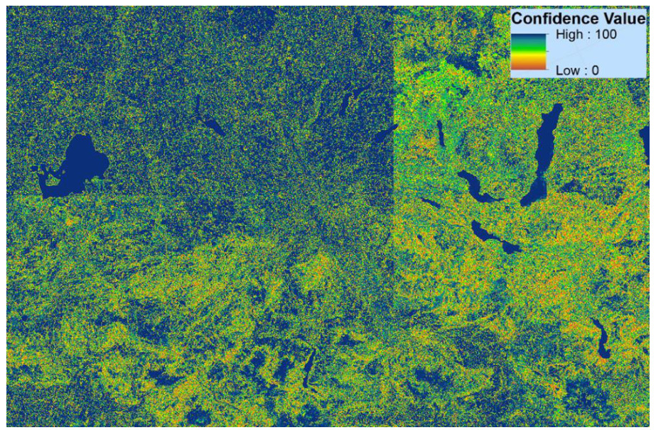 This map displays the spatial distribution of Confidence Values for the Copernicus Land Monitoring Service (CLMS) CLC+ (next-generation CORINE Land Cover) Backbone Raster Data Score Layer (RASDL), likely for the reference year 2023. The map shows a landscape featuring numerous lakes, predominantly rendered in dark blue. A legend in the top right corner indicates 'Confidence Value,' with a colour gradient ranging from green for 'High : 100' to blue for 'Low : 0,' passing through yellow and orange. Areas of high confidence (bright green) are widely distributed, interspersed with areas of lower confidence (yellow and orange). Dark blue regions correspond to very low confidence values, most notably for the large bodies of water. The map appears to be composed of two adjacent map tiles, with a vertical seam slightly right of the center. The visual pattern suggests a varied confidence level across the landscape, with water bodies consistently showing the lowest confidence values.